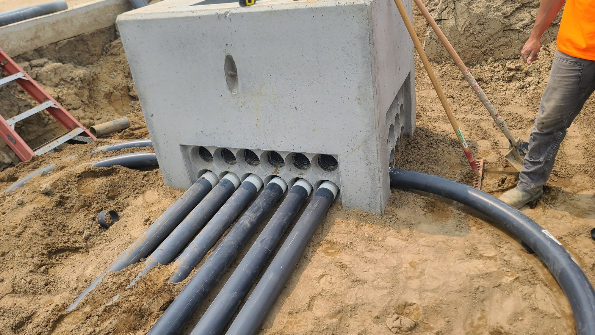 Concrete utility box with conduit pipes installation
